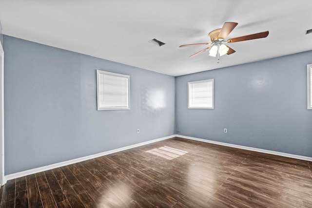 spare room featuring dark hardwood / wood-style floors and ceiling fan