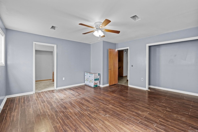 unfurnished bedroom with ceiling fan and dark hardwood / wood-style flooring