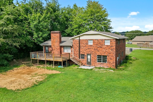 rear view of property featuring a deck and a lawn