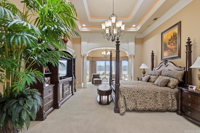 bedroom featuring ornamental molding, a tray ceiling, a notable chandelier, a towering ceiling, and decorative columns