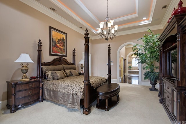 carpeted bedroom featuring crown molding, a tray ceiling, and a notable chandelier