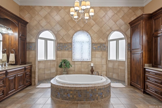 bathroom with vanity, a relaxing tiled tub, tile patterned floors, and crown molding