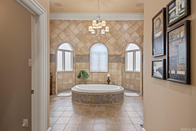 bathroom featuring ornamental molding, a relaxing tiled tub, a notable chandelier, and tile patterned floors