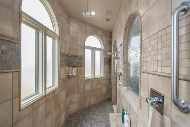 bathroom with tiled shower