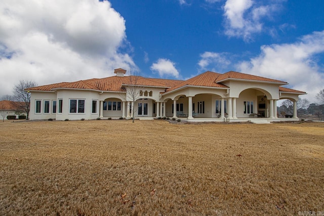 rear view of property featuring a yard