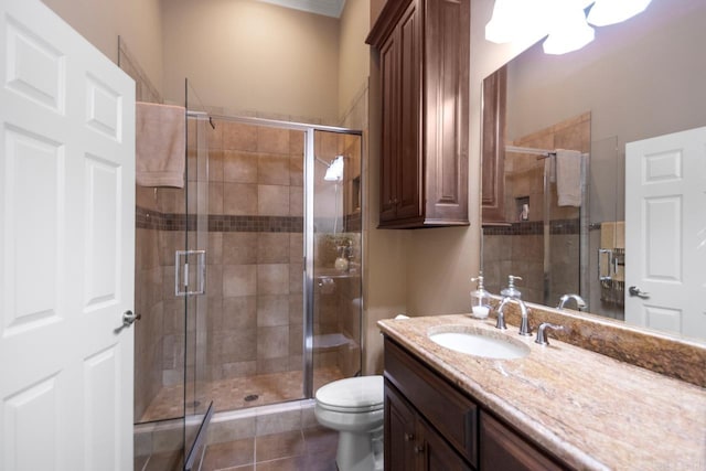 bathroom with vanity, tile patterned floors, toilet, and walk in shower