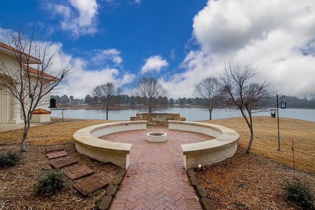 view of patio featuring a fire pit and a water view