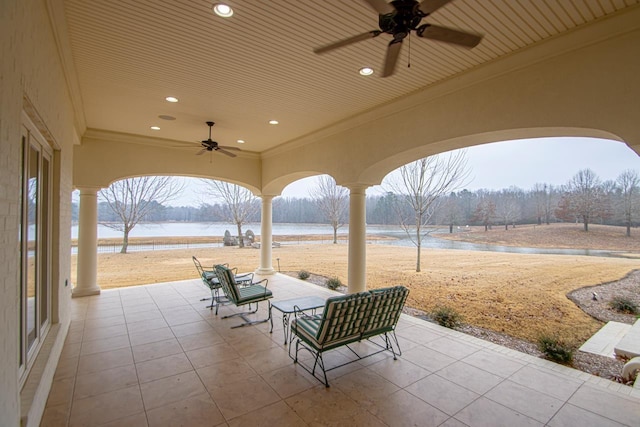 view of patio / terrace featuring a water view and ceiling fan