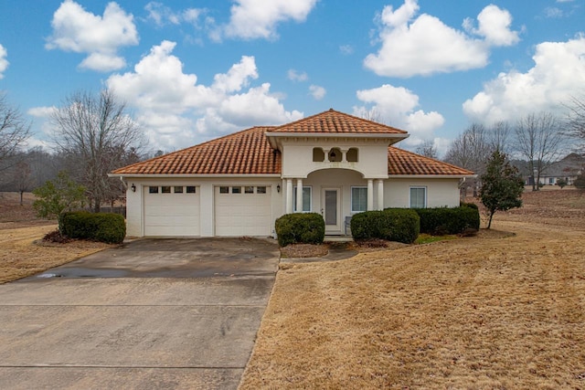 mediterranean / spanish-style house with a garage