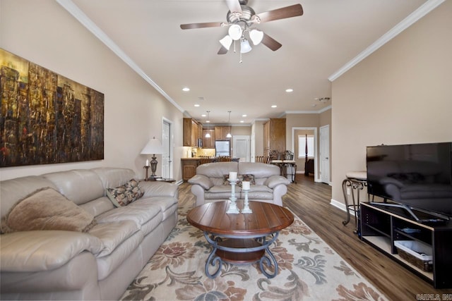 living room with crown molding, hardwood / wood-style flooring, and ceiling fan