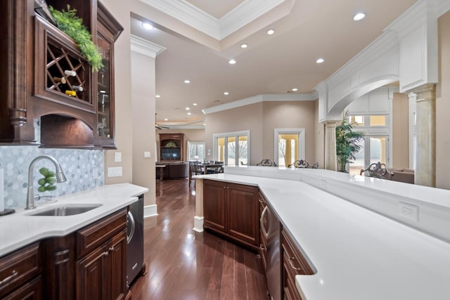 kitchen with dark hardwood / wood-style floors, decorative columns, sink, decorative backsplash, and crown molding