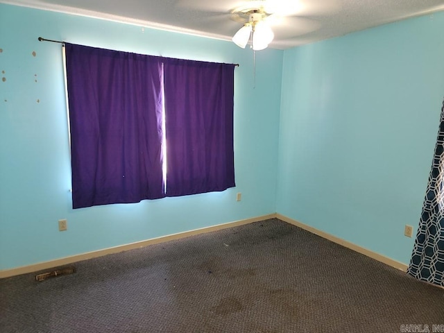 spare room featuring carpet floors and ceiling fan