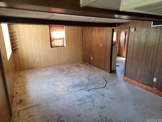 basement featuring wood walls