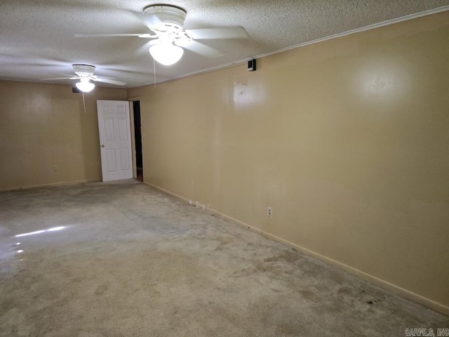 carpeted spare room featuring ceiling fan, crown molding, and a textured ceiling