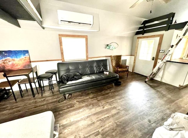 living room with lofted ceiling, dark hardwood / wood-style floors, an AC wall unit, and ceiling fan