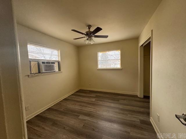 unfurnished bedroom with ceiling fan, a closet, dark hardwood / wood-style flooring, and multiple windows