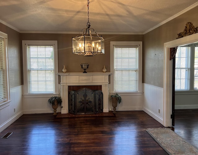 unfurnished living room featuring crown molding, dark wood-type flooring, and a wealth of natural light