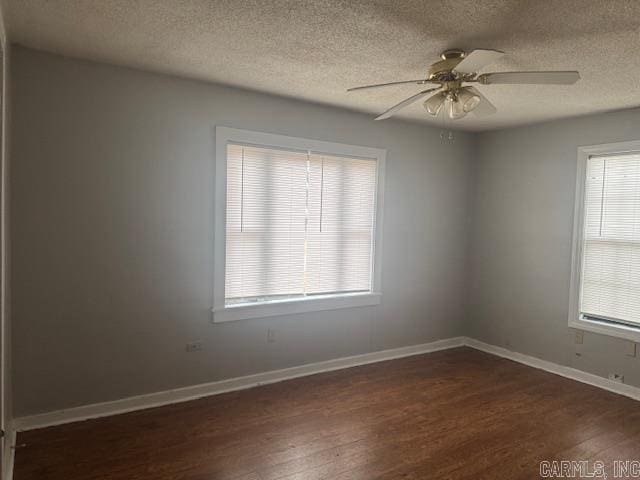 spare room featuring ceiling fan, a textured ceiling, and dark hardwood / wood-style flooring