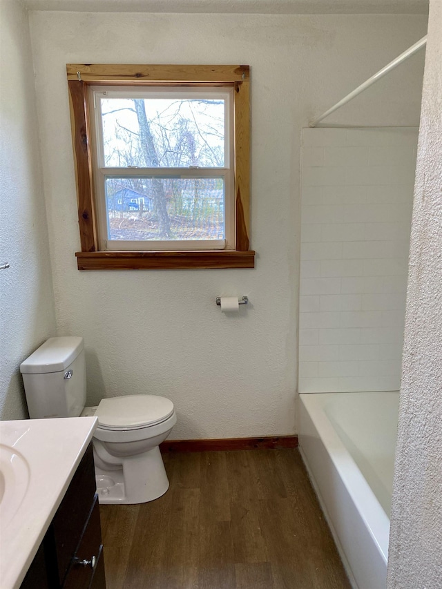 full bathroom featuring shower / bath combination, vanity, hardwood / wood-style floors, and toilet