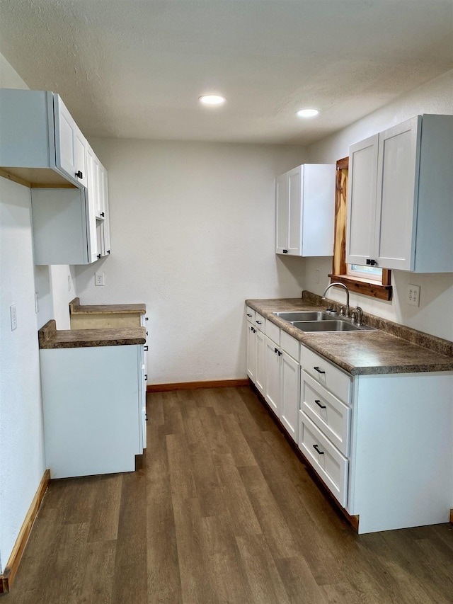 kitchen featuring sink, white cabinets, and dark hardwood / wood-style flooring