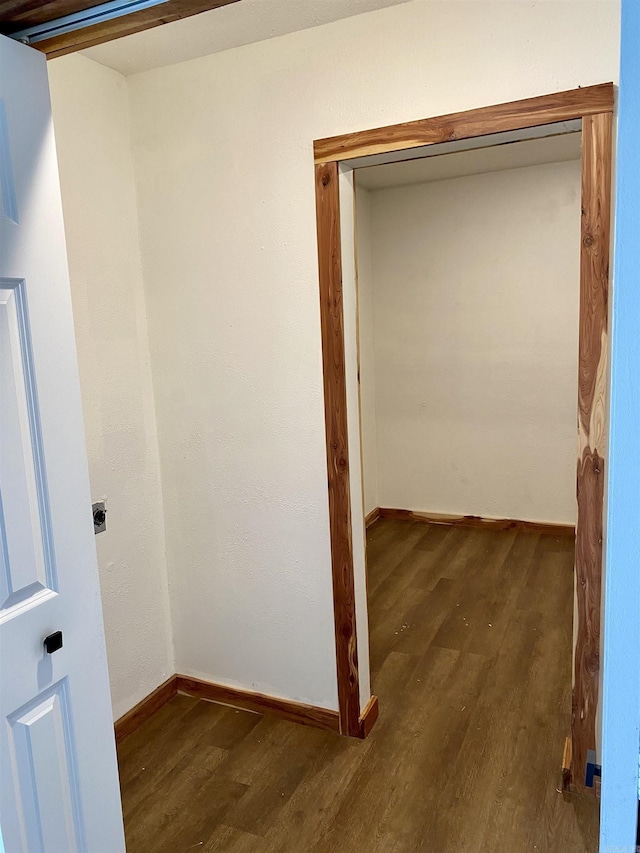 hallway with dark hardwood / wood-style floors