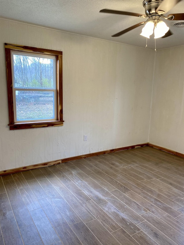 unfurnished room with hardwood / wood-style flooring, ceiling fan, and a textured ceiling