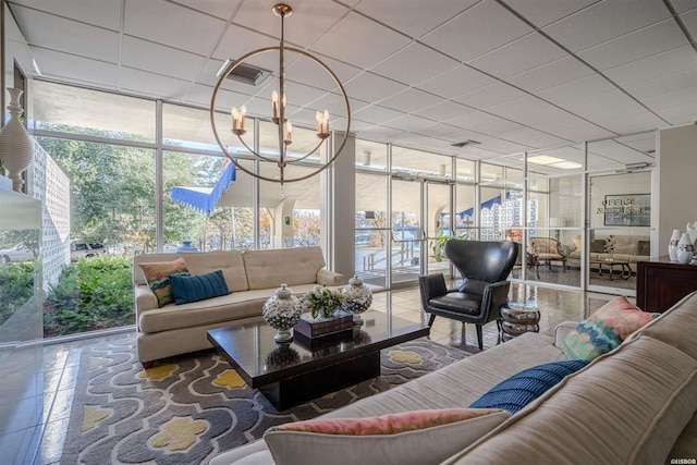 sunroom with a notable chandelier and a paneled ceiling