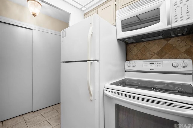 kitchen with tasteful backsplash, light tile patterned floors, and white appliances