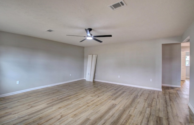 spare room featuring ceiling fan, a textured ceiling, and light hardwood / wood-style floors