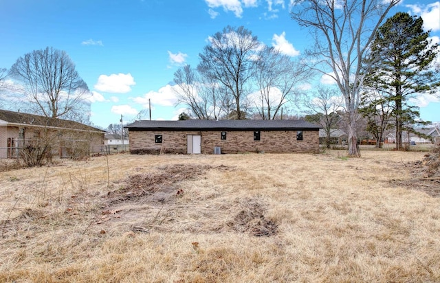 rear view of property with a yard