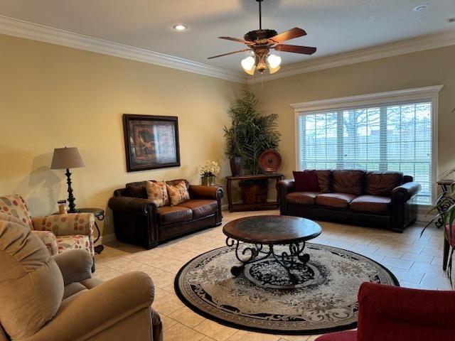 tiled living room with crown molding and ceiling fan