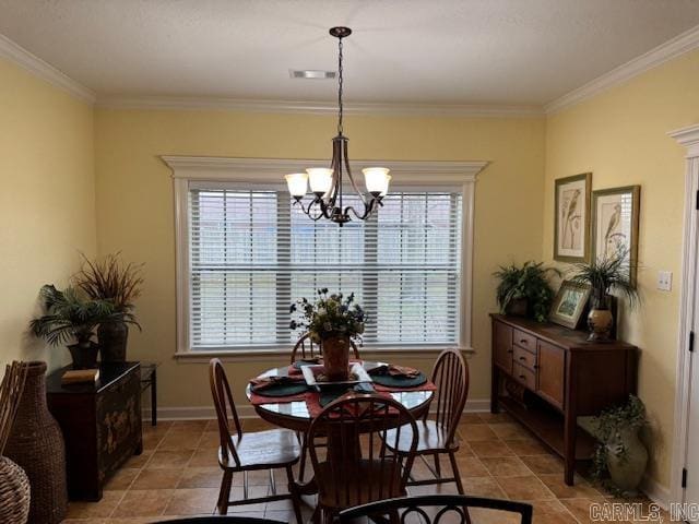 tiled dining area featuring ornamental molding and a notable chandelier