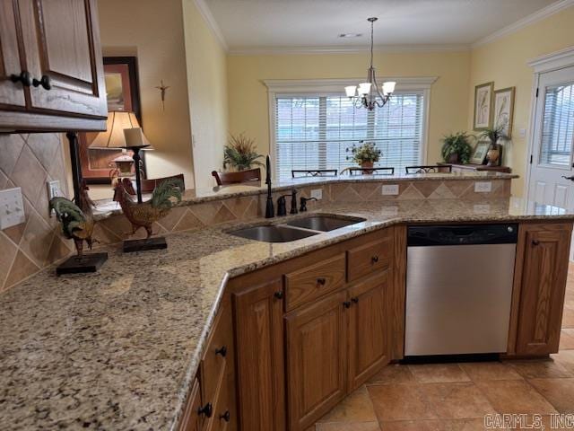 kitchen featuring sink, tasteful backsplash, crown molding, dishwasher, and pendant lighting