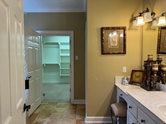 bathroom with crown molding and vanity