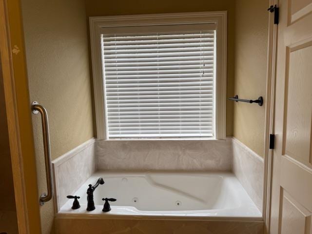 bathroom with tiled tub