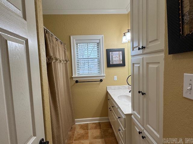 bathroom with ornamental molding, vanity, and tile patterned floors