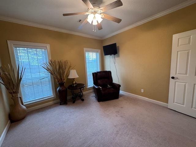 living area featuring crown molding, light carpet, and ceiling fan