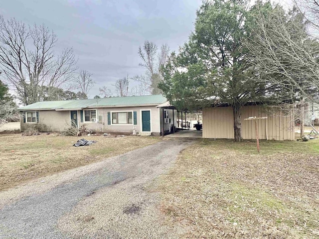 view of front of property with a carport and a front yard