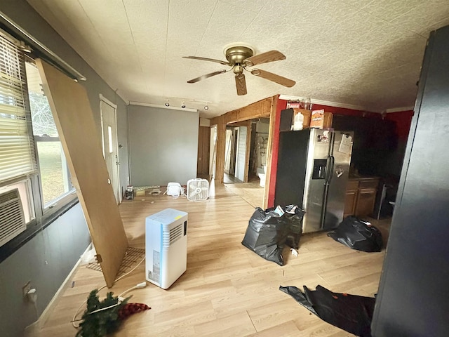 interior space featuring ceiling fan, a textured ceiling, stainless steel fridge, and light hardwood / wood-style floors