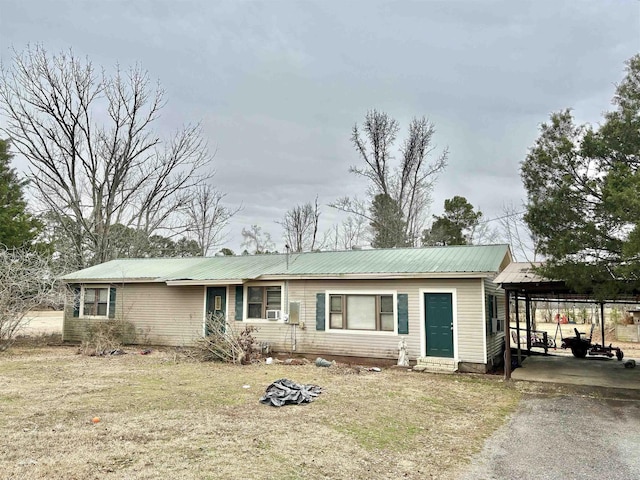 ranch-style home with a front yard and a carport