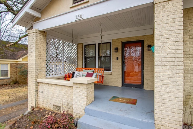 entrance to property featuring covered porch