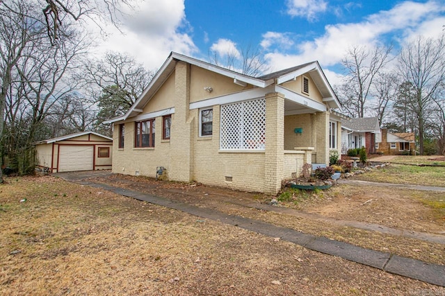 view of side of property with a garage and an outdoor structure