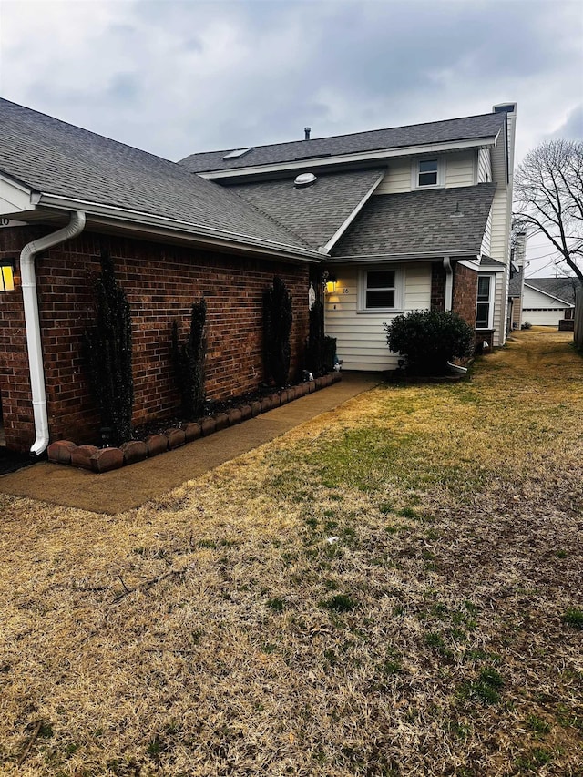 rear view of property with a yard