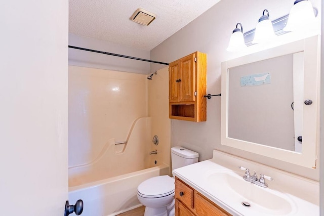 full bathroom featuring vanity, toilet, a textured ceiling, and shower / bath combination