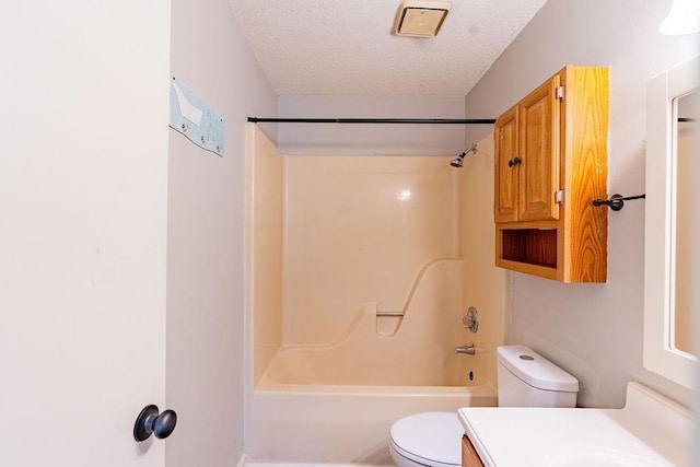 full bathroom featuring vanity, toilet, a textured ceiling, and shower / bath combination