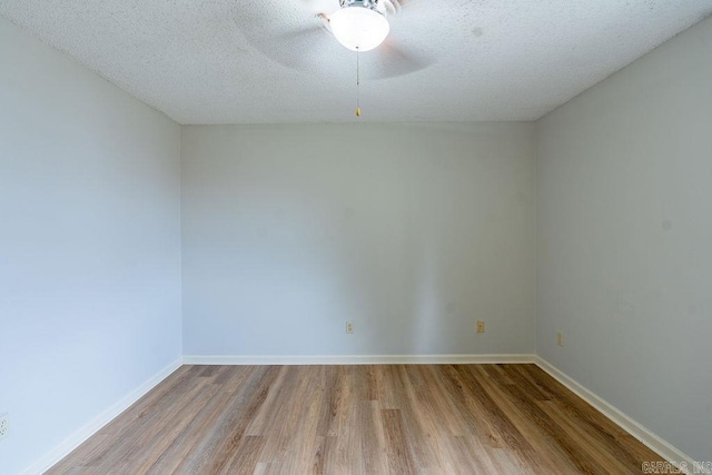 unfurnished room featuring ceiling fan, light hardwood / wood-style flooring, and a textured ceiling