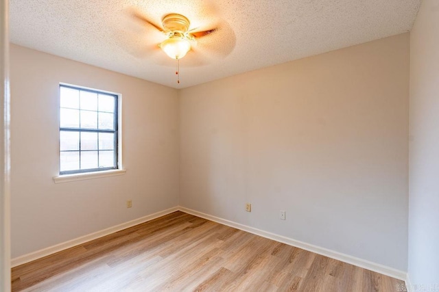 spare room with ceiling fan, a textured ceiling, and light wood-type flooring