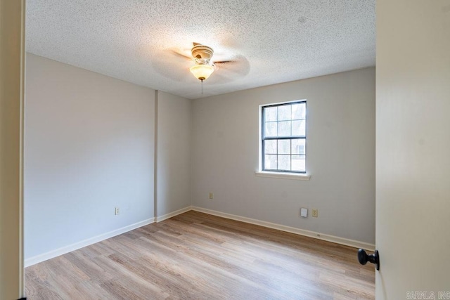 empty room featuring ceiling fan, a textured ceiling, and light hardwood / wood-style floors