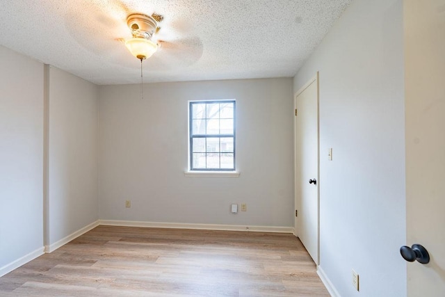 unfurnished room featuring a textured ceiling and light hardwood / wood-style floors