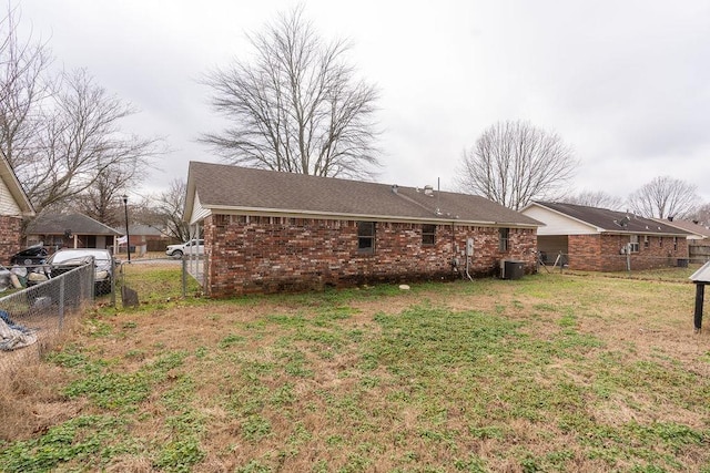 exterior space with central AC and a lawn